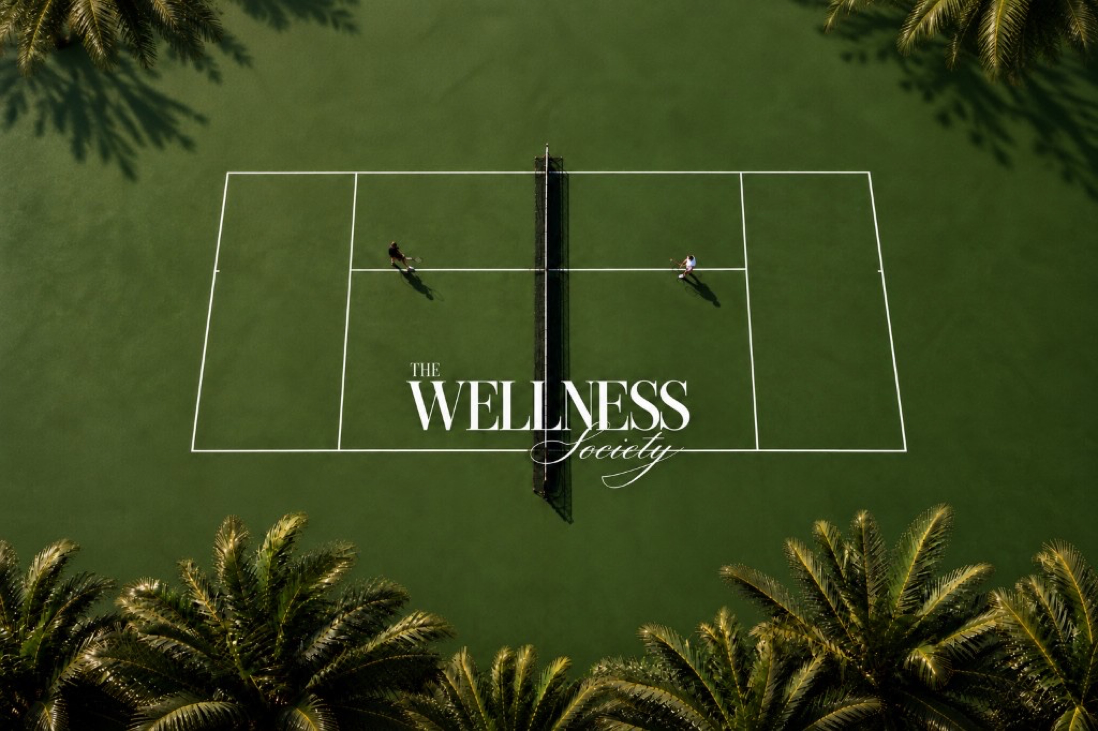 The Wellness Society — aerial tennis court with script wordmark